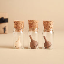 Load image into Gallery viewer, small-wooden-spinning-tops-in-glass-jars-with-cork