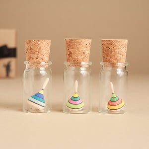 colorful-stripe-mini-spinning-topp-in-glass-jars-with-corks