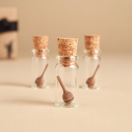 mini-wooden-spinning-tops-in-glass-jars-with-corks