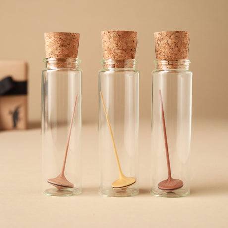 mini-wooden-spinning-top-with-long-thin-handle-in-glass-jars-with-corks