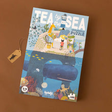 Load image into Gallery viewer, Tea-by-the-Sea-100-piece-Interactive-Puzzle-box-with-a-whale-under-an-island-with-coral-beneath-the-water-and-a-tea-party-above