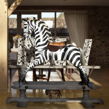 Load image into Gallery viewer, rocking-zebra-in-home-with-a-dining-table-in-background-mounted-on-a-safety-stand-with-no-saddle-blanket