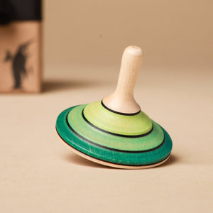 green-stripe-on-light-wood-tango-spinning-top