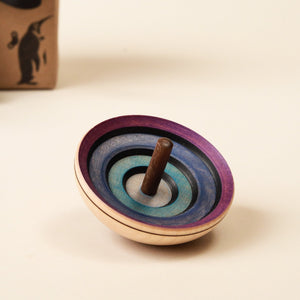 ufo-shaped-spinning-top-dark-colors-and-black-spiral
