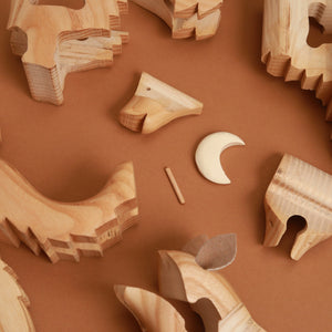 wooden-moon-surrounded-by-scattered-pieces