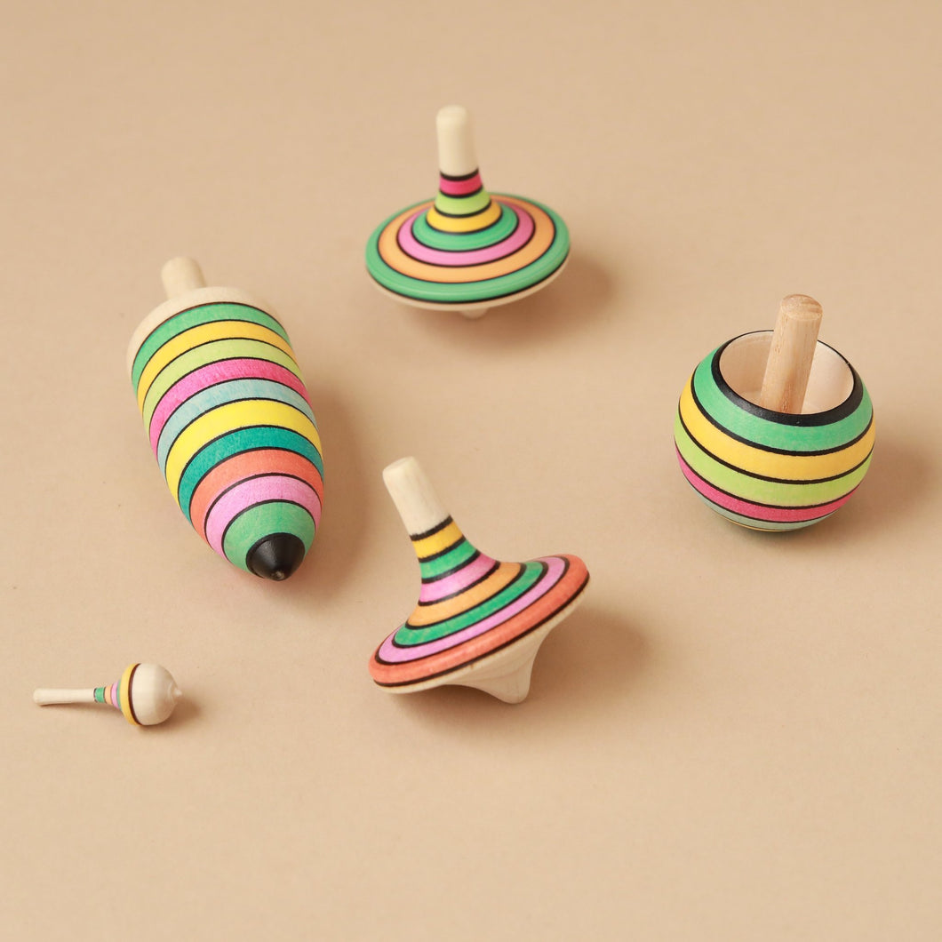 set-of-5-wooden-tops-in-different-shapes-with-spring-colored-stripes