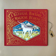 Load image into Gallery viewer, Front-cover-Natural-History-of-Magical-Beast-book-vibrant-red-cover-with-unicorn-and-gold-foil-text