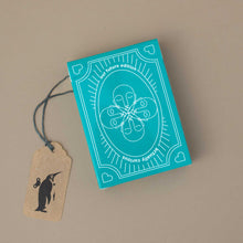 Load image into Gallery viewer, card-game-box-in-turquoise-with-illustration-of-faces