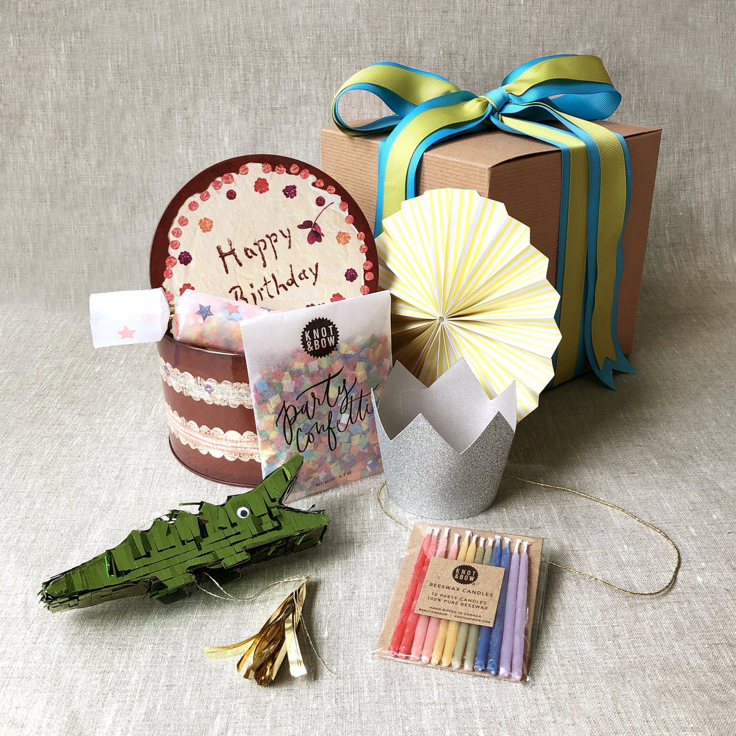 birthday-in-a-box-with-confetti-party-poppers-crocodile-favor-candles-and-silver-crown