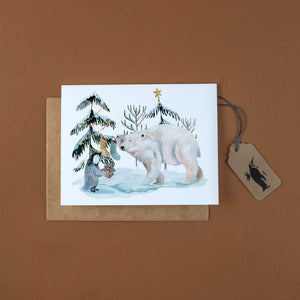    arctic-holiday-greeting-card-with-penguin-and-polar-bear-decorating-trees