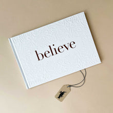 Load image into Gallery viewer, believe-book-white-cover-with-gold-lettering-and-imprinted-floral-design