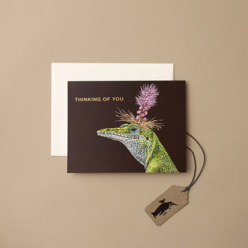 Lizard-illustration-with-flower-on-its-head-and-words-thinking-of-you-on-dark-background