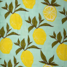 Load image into Gallery viewer, detail-of-pattern-with-yellow-lemons-and-green-leafs-on-a-light-blue-background