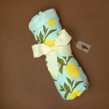 Load image into Gallery viewer, rolled-baby-blanket-with-yellow-lemons-and-green-leafs-on-a-light-blue-background-with-a-yellow-ribbon