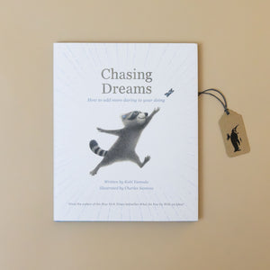 chasing-dreams-book-cover-with-a-racoon-chasing-a-butterfly