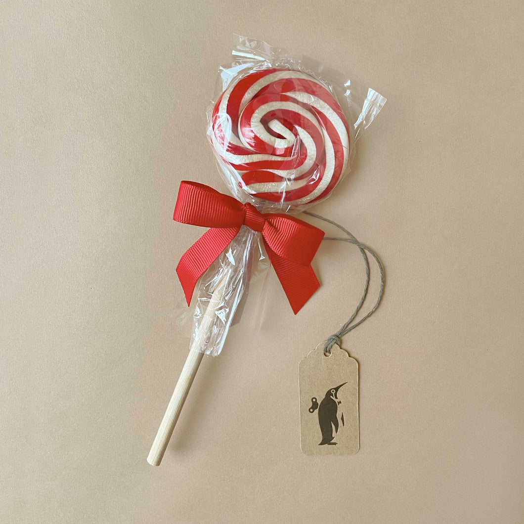 red-and-white-swirl-lollipop-on-white-stick-tied-with-red-ribbon