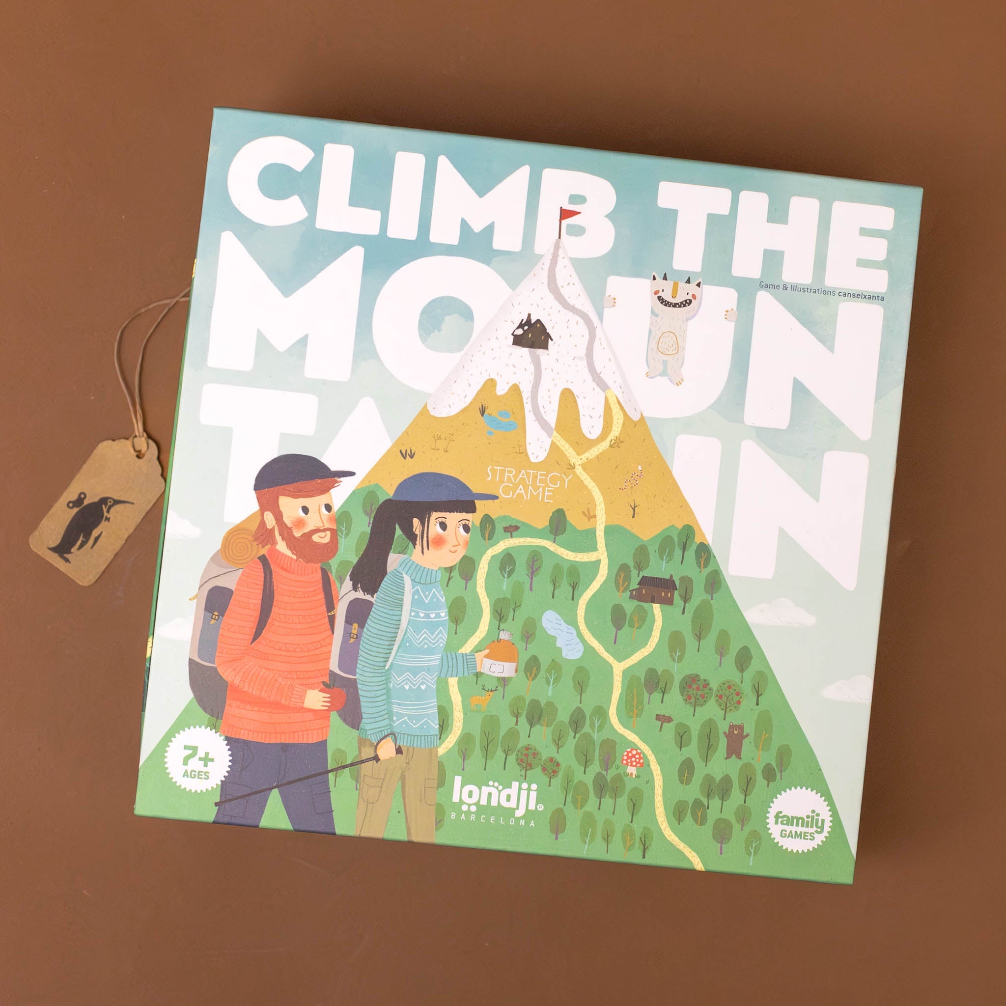 climb-the-mountain-family-game-box-with-two-backpackers-looking-at-a-mountain-to-climb