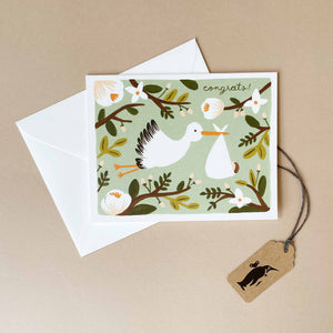 greeting-card-with-stork-on-green-and-floral-background-with-the-word-congrats-in-script