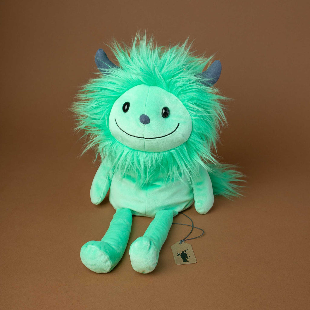 green-monster-with-a-big-smiley-face-and-fluffy-hair-around-his-head-and-two-small-grey-horns