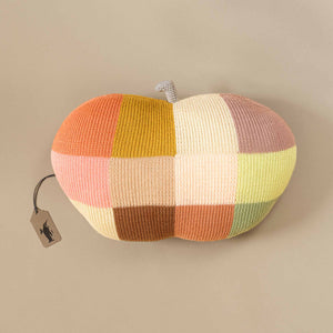 handknit-cotton-apple-pillow-in-patchwork-of-muted-orange-pinks-cream-brown-and-green