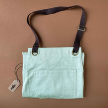 Load image into Gallery viewer, cotton-twill-apron-in-sage-color-shown-folded-with-top-pocket-showing-and-adjustable-brown-neck-loop