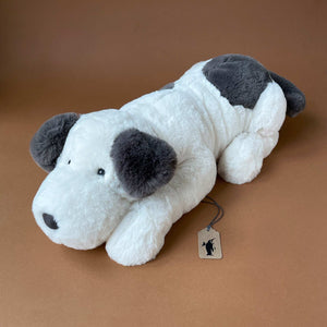 black-white-dog-stuffed-animal-laying-down