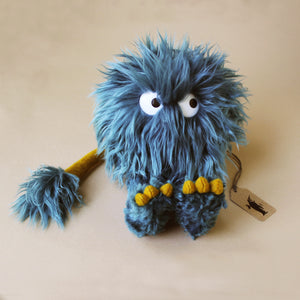 Les-Schmouks-Choukette-blue-fuzzy-monster-with-a-tail-and-clawed-feet