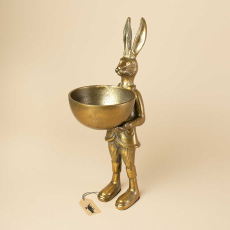 golden-metallic-rabbit-wearing-clothes-and-holding-a-golden-bowl