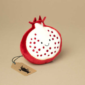 dark-red-round-open-cut-pomegranate-with-white-smiley-face-and-red-dots