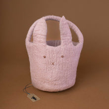 Load image into Gallery viewer, felted-round-basket-with-handle-in-lavender-color-and-a-bunny-face-embroidery-on-the-front