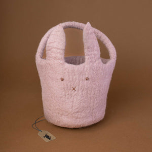 felted-round-basket-with-handle-in-lavender-color-and-a-bunny-face-embroidery-on-the-front