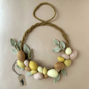 felted-wreath-with-felted-eggs-and-leaves-in-various-yellow-and-brown-colors