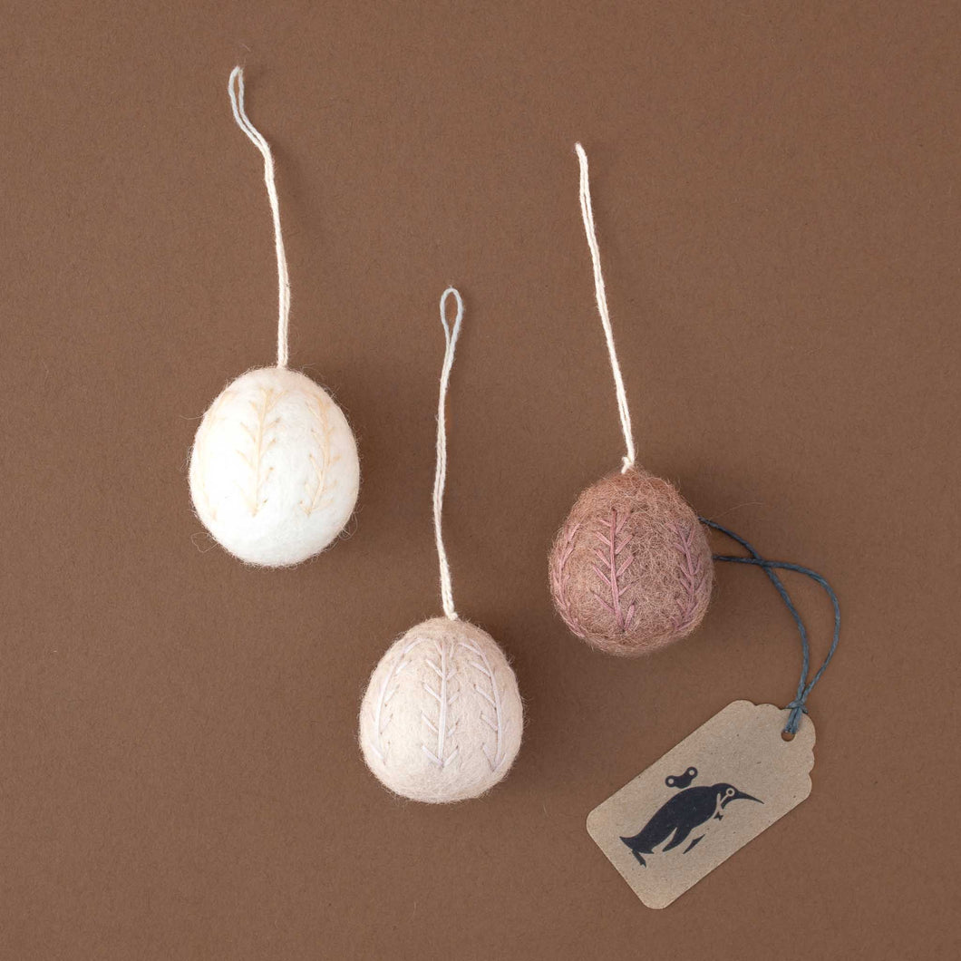 three-felted-eggs-with-same-color-embroidery-in-white-rose-and-lavender