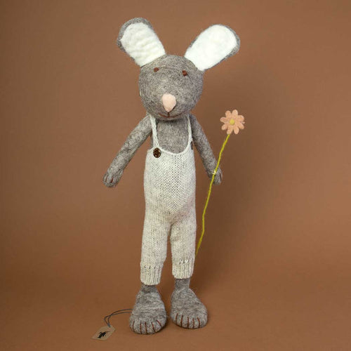 grey-felted-rabbit-in-jumbo-size-wearing-a-knitted-beige-overall-and-holding-an-orange-flower-in-its-hand