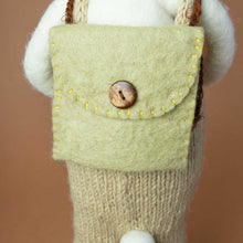 Load image into Gallery viewer, detail-of-backside-showing-a-sage-green-backpack-closed-with-a-wooden-brown-button