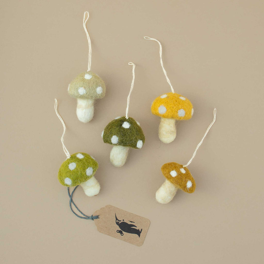 five-felted-mushroom-ornaments-in-sage-yellow-dark-green-light-green-and-ochre