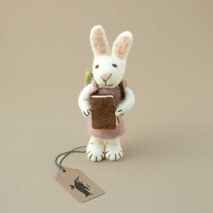 small-white-bunnz-ornament-with-knitted-lavender-colored-dress-holding-a-brown-book-iher-hands