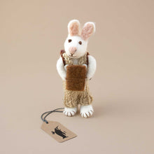 Load image into Gallery viewer, standing-white-felted-rabbit-with-sage-green-knitted-overall-holding-a-book-and-wearing-a-backpack