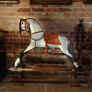 rocking-horse-shown-next-to-interior-brick-wall