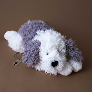 grey-and-white-curly-haired-sheepdog-stuffed-animal-in-lying-position
