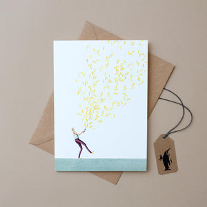 boy-popping-glitter-bomb-filled-with-yellow-confetti-on-white-background