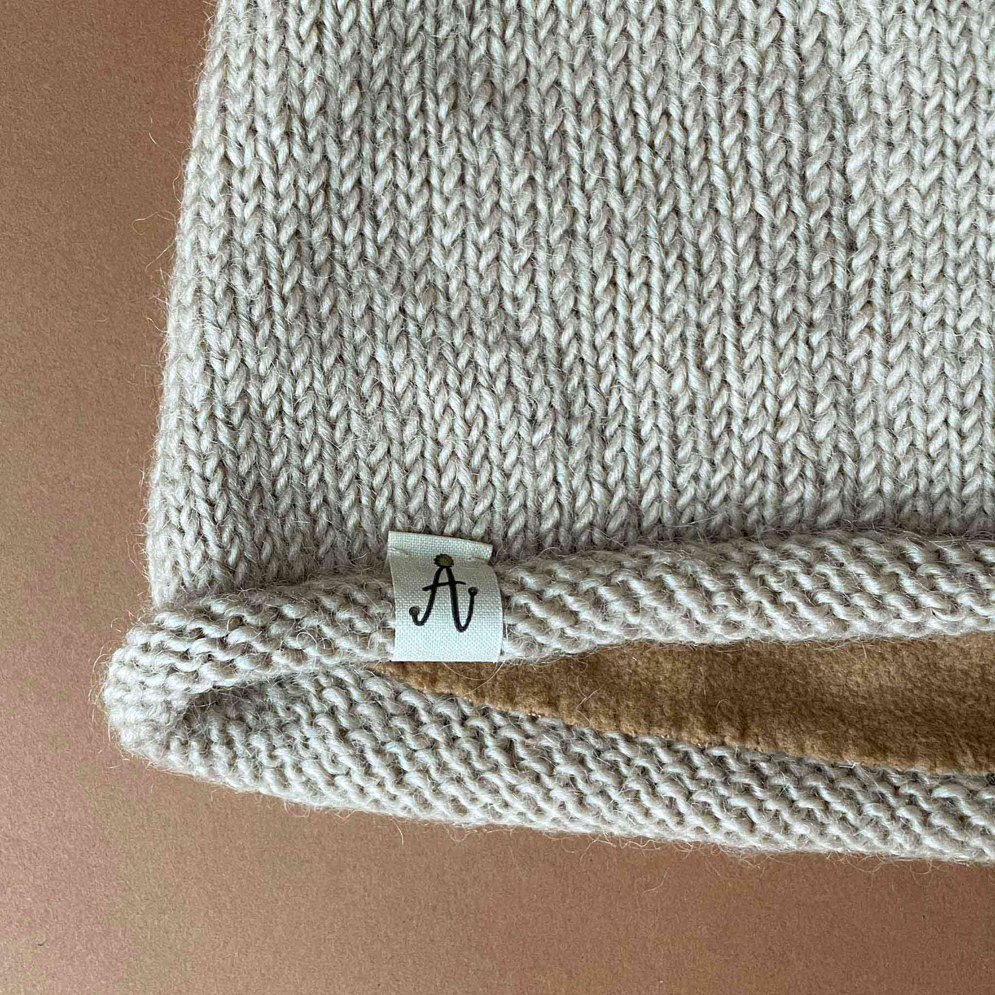 close-up-of-hand-knit-hunter-hat-label