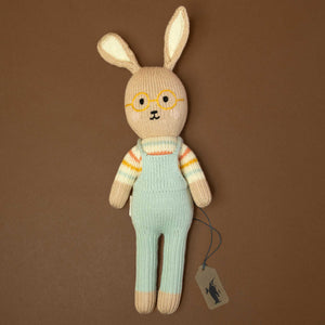 hand-knit-bunny-with-long-ears-waring-yellow-glasses-and-a-blue-overall-and-striped-shirt
