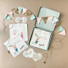 Load image into Gallery viewer, open-metal-tin-showing-contents-of-party-napkins-and-garland