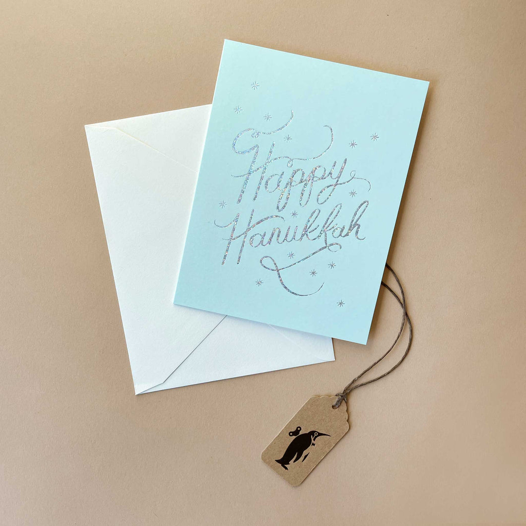 happy-hanukkah-in-silver-metallic-script-on-baby-blue-background-with-white-envelope