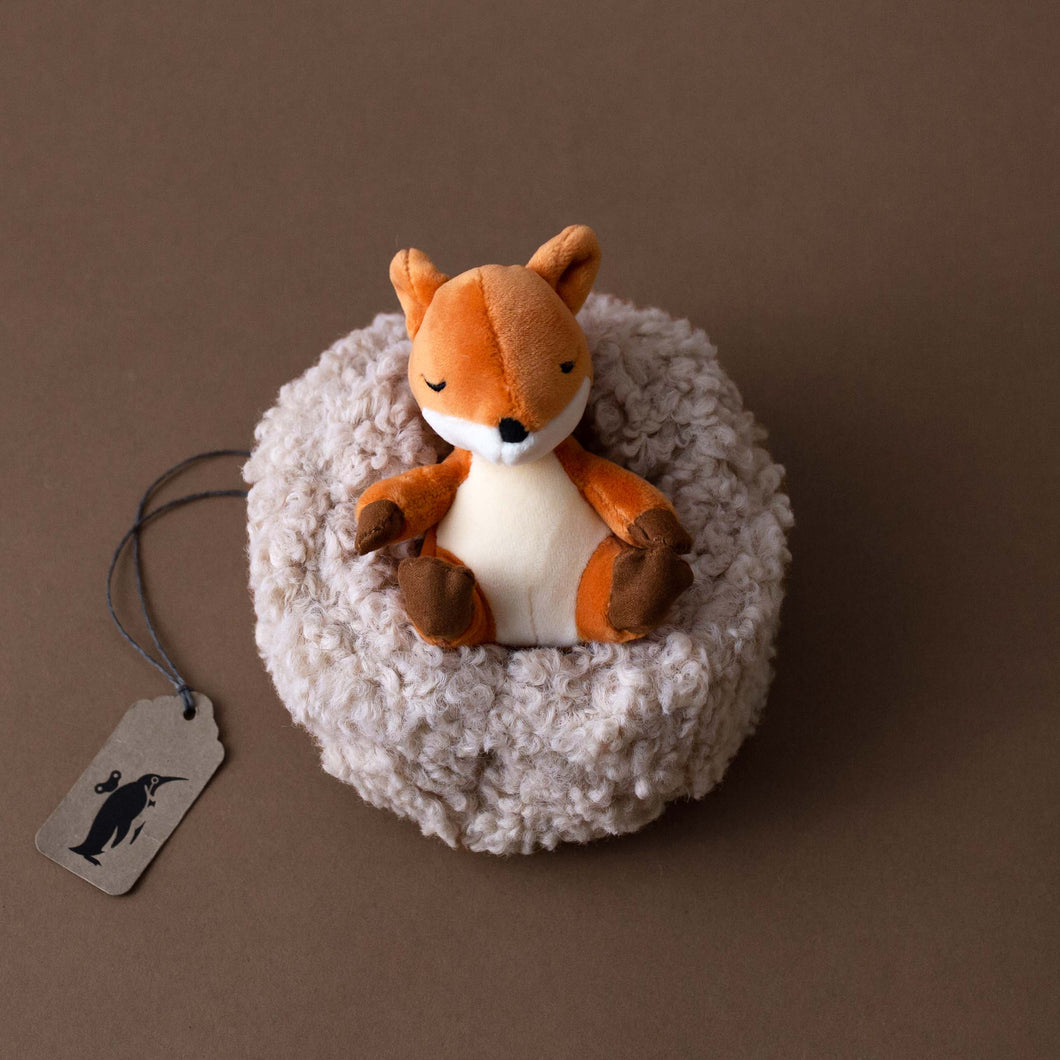 small-orange-fox-stuffed-animal-in-oatmeal-nest