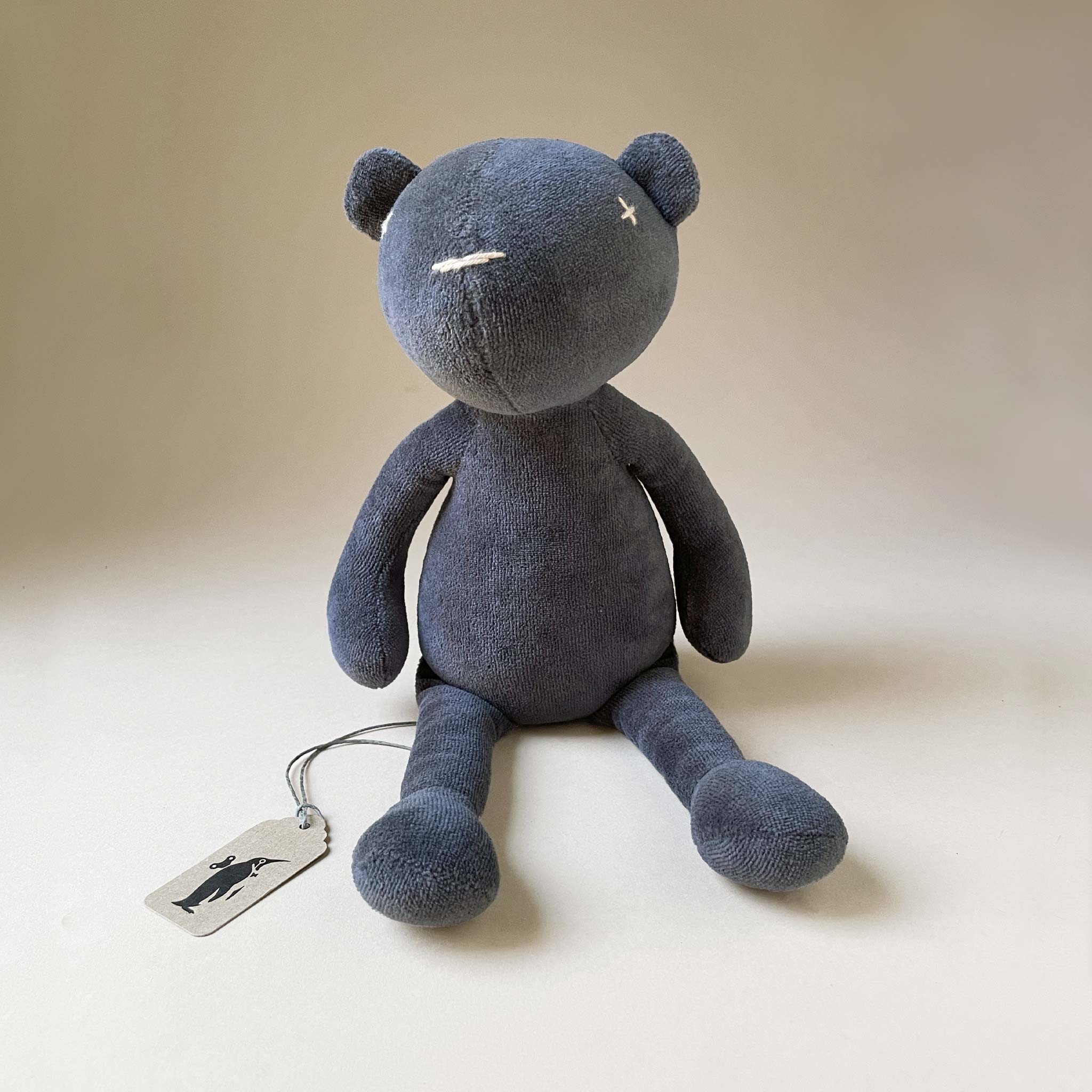 dark-grey-bear-plush-sitting-upright