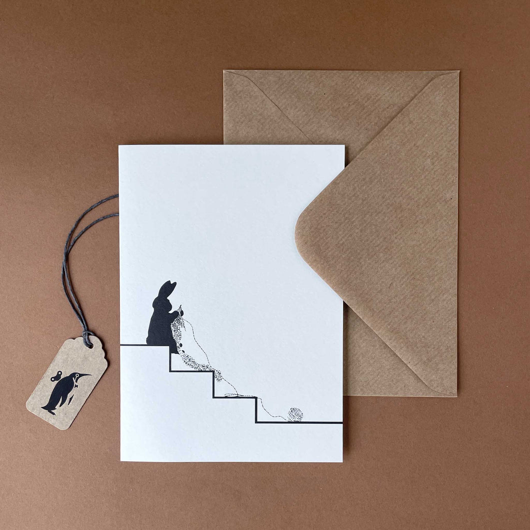 silhouetted-rabbit-sitting-on-stairs-knitting