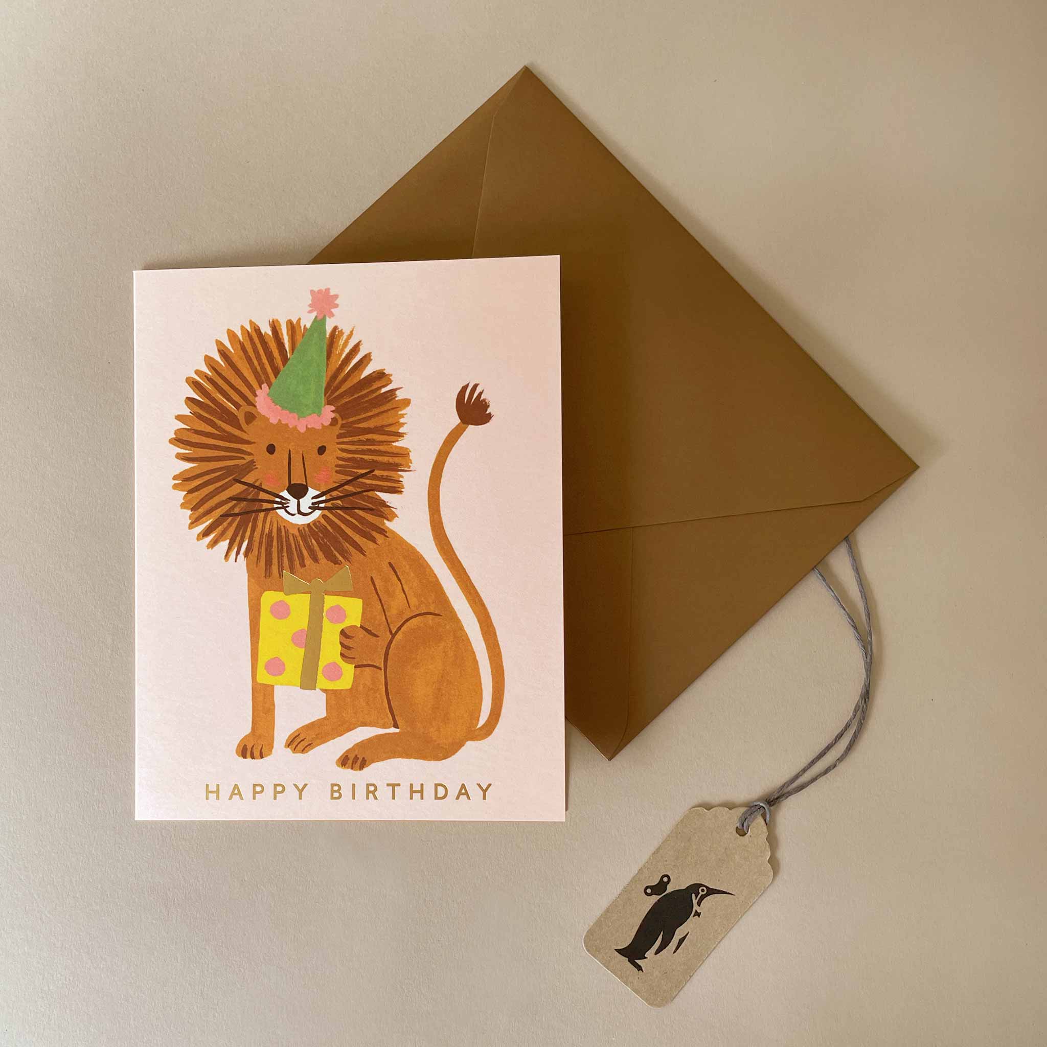 birthday-card-lion-holding-wrapped-gift-wearing-green-party-hat