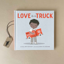 Load image into Gallery viewer, love-is-a-truck-book-cover-featuring-the-title-in-red-letters-and-a-young-child-in-checkered-overalls-holding-a-red-fire-truck